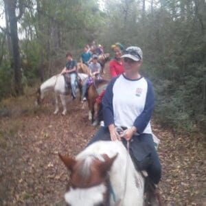 Group trail riding through woods